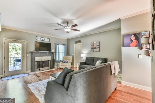 37 Wood Duck Pt, Jefferson, GA 30549 - living area featuring light wood finished floors, a fireplace, a ceiling fan, and crown molding