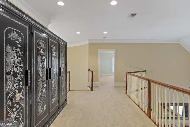 hall with light colored carpet, crown molding, baseboards, an upstairs landing, and recessed lighting
