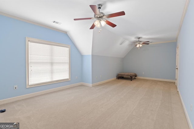 additional living space featuring baseboards, light carpet, a ceiling fan, and visible vents