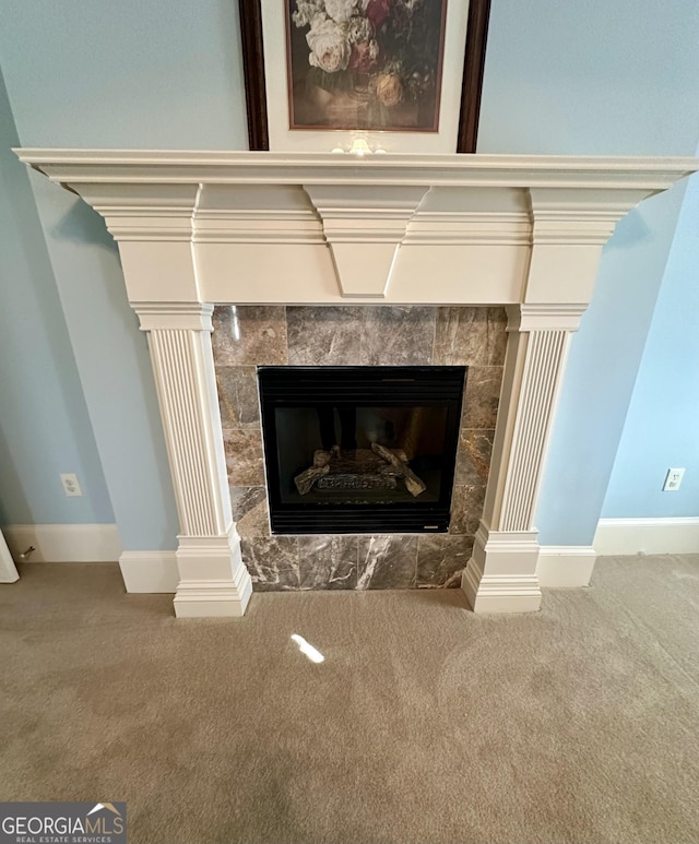 interior details featuring ornate columns, baseboards, carpet, and a fireplace