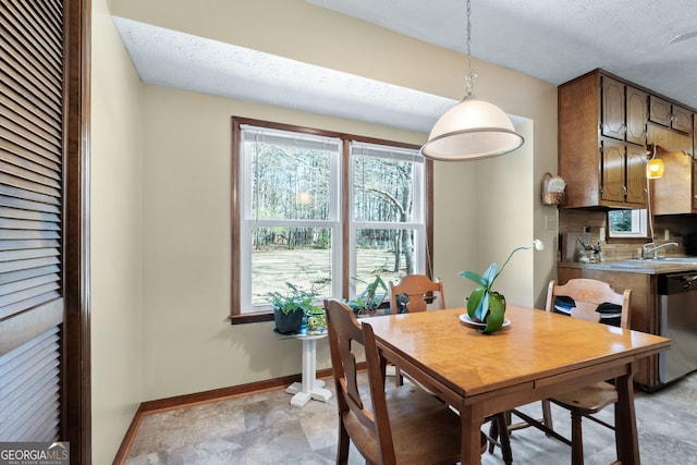 dining room with baseboards and a textured ceiling