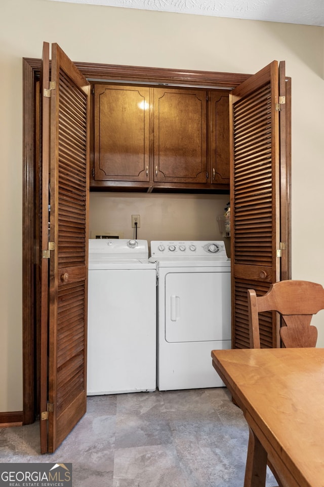 laundry room featuring cabinet space and washing machine and dryer