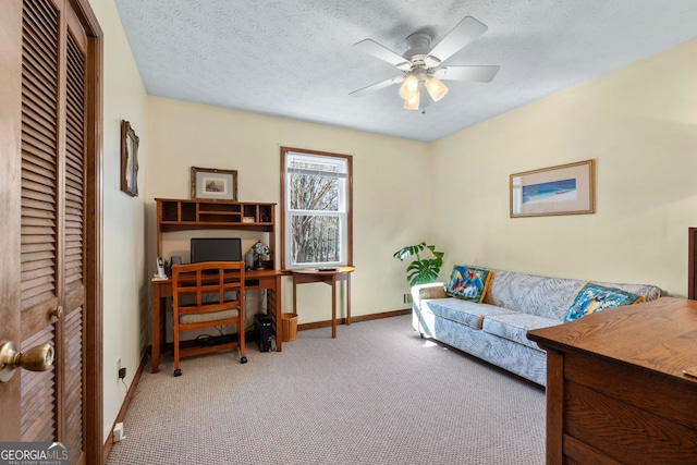 office area with baseboards, carpet, a ceiling fan, and a textured ceiling