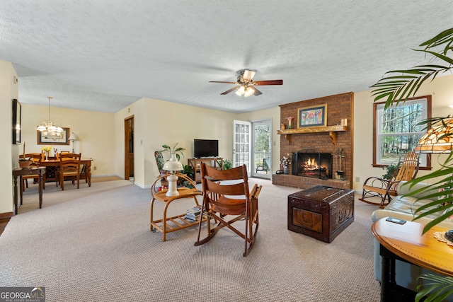 living area with carpet flooring, a brick fireplace, a textured ceiling, ceiling fan with notable chandelier, and baseboards