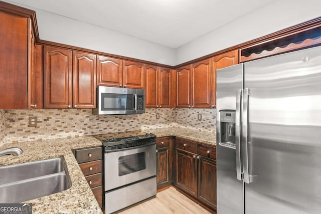 1502 River Green Dr NW Unit 1502, Atlanta, GA 30327 - kitchen featuring backsplash, stainless steel appliances, light stone countertops, and a sink
