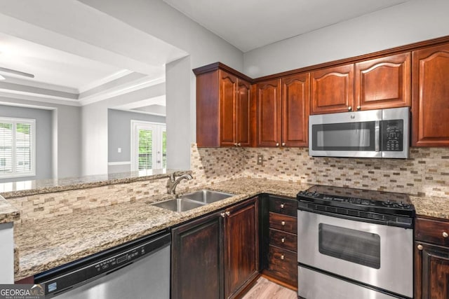 1502 River Green Dr NW Unit 1502, Atlanta, GA 30327 - kitchen with backsplash, light wood-type flooring, a sink, light stone counters, and stainless steel appliances