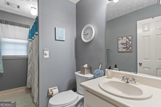 full bathroom featuring toilet, a textured ceiling, visible vents, and vanity
