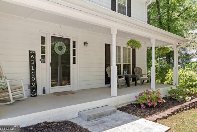 view of exterior entry featuring a porch