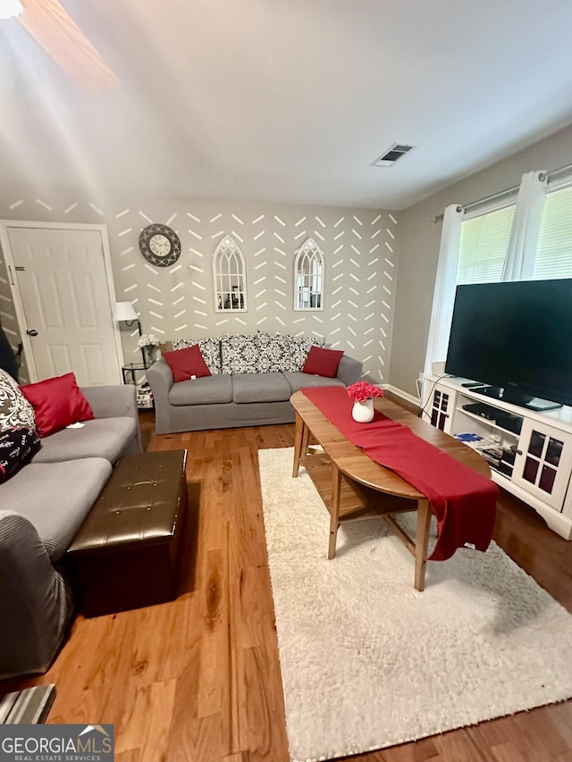 living room with wood finished floors and visible vents