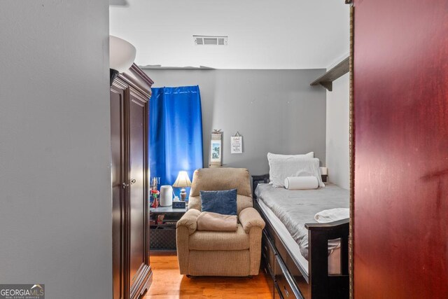 bedroom featuring visible vents and light wood finished floors