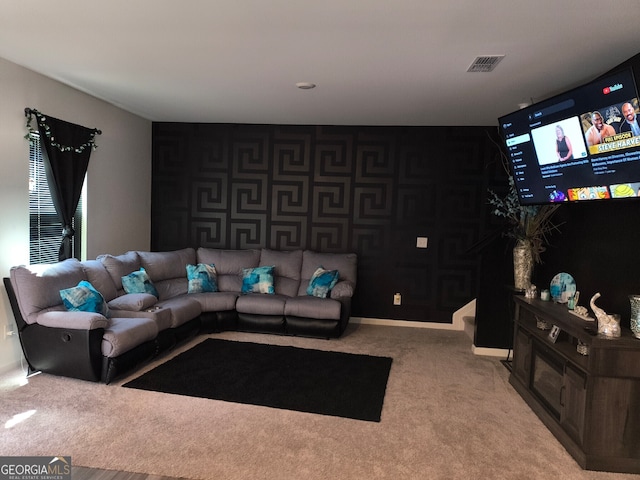 carpeted living area featuring baseboards and visible vents