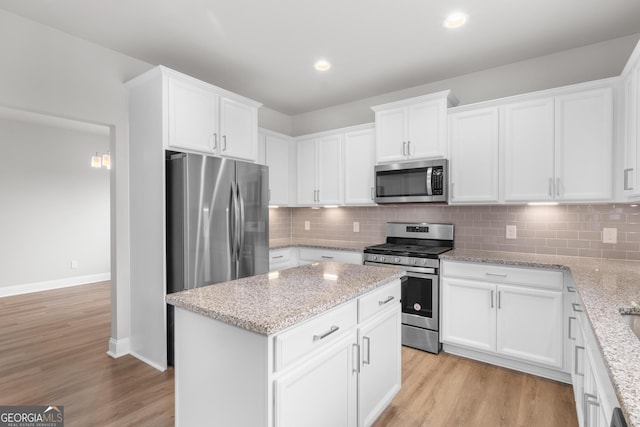kitchen featuring white cabinets, appliances with stainless steel finishes, and light wood-type flooring