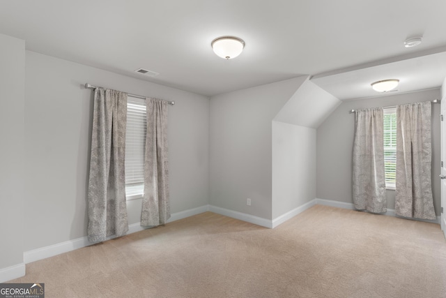 additional living space featuring baseboards, carpet flooring, and visible vents