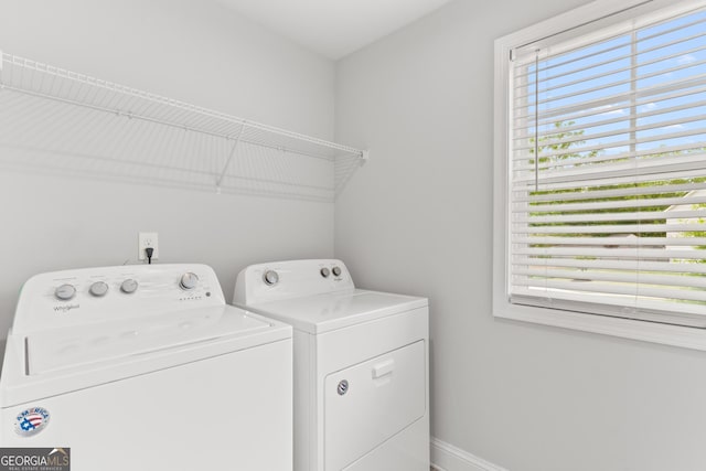 laundry area featuring independent washer and dryer, laundry area, and baseboards