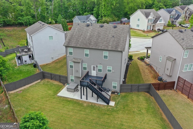 rear view of property with a residential view, a gate, a fenced backyard, a yard, and a patio