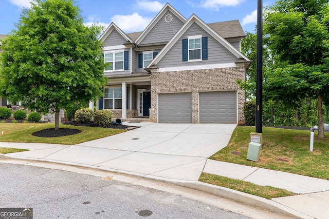 view of front of house with brick siding, driveway, a front yard, and a garage