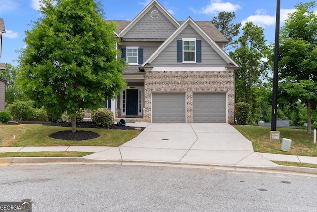 craftsman-style house with brick siding, a front lawn, an attached garage, and driveway