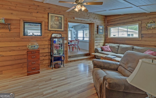 76 Periwinkle Ln, Cleveland, GA 30528 - living area featuring light wood-style floors, wooden walls, and a healthy amount of sunlight