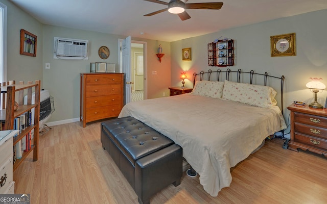 76 Periwinkle Ln, Cleveland, GA 30528 - bedroom featuring baseboards, light wood-style flooring, ceiling fan, and a wall unit AC