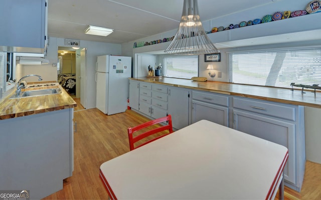 76 Periwinkle Ln, Cleveland, GA 30528 - kitchen featuring a sink, wood counters, freestanding refrigerator, and light wood-style floors