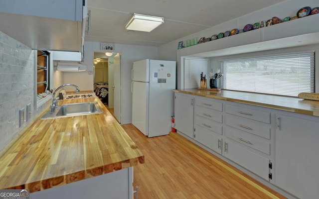 76 Periwinkle Ln, Cleveland, GA 30528 - kitchen with freestanding refrigerator, a sink, and butcher block counters