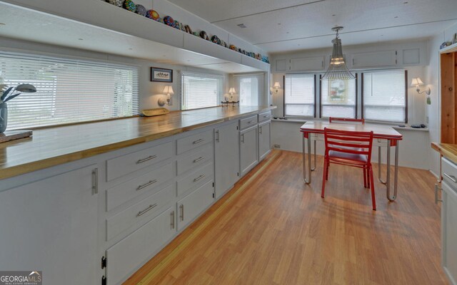 76 Periwinkle Ln, Cleveland, GA 30528 - kitchen featuring light wood finished floors, wood counters, and white cabinets