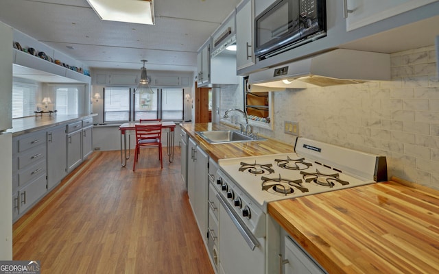 76 Periwinkle Ln, Cleveland, GA 30528 - kitchen with black microwave, white range with gas stovetop, butcher block counters, and a sink