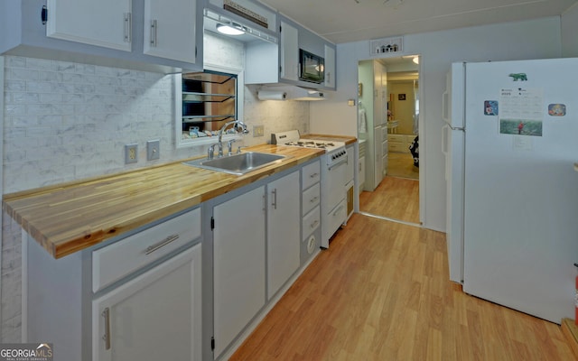 76 Periwinkle Ln, Cleveland, GA 30528 - kitchen featuring tasteful backsplash, white cabinetry, a sink, white appliances, and light wood-style flooring