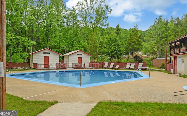 76 Periwinkle Ln, Cleveland, GA 30528 - pool with fence, an outdoor structure, and a patio area