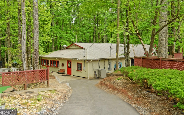 76 Periwinkle Ln, Cleveland, GA 30528 - view of front of house with ac unit, a wooded view, and aphalt driveway