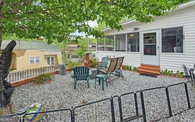 76 Periwinkle Ln, Cleveland, GA 30528 - view of patio / terrace featuring entry steps, a sunroom, and a fenced backyard