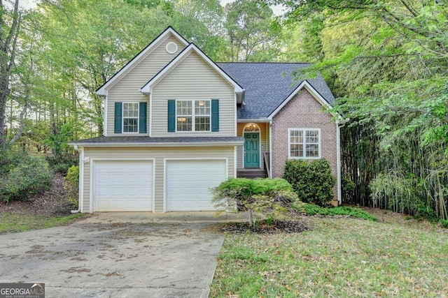 tri-level home featuring concrete driveway, brick siding, an attached garage, and a shingled roof