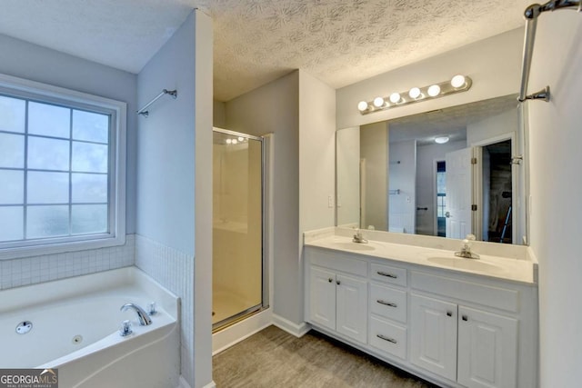 bathroom with double vanity, a sink, and a stall shower