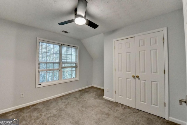unfurnished bedroom featuring ceiling fan, visible vents, baseboards, a closet, and carpet
