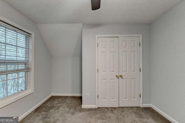 additional living space with baseboards, a ceiling fan, carpet, and a wealth of natural light