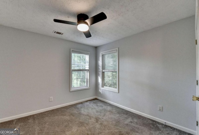 spare room featuring baseboards, ceiling fan, carpet, and visible vents