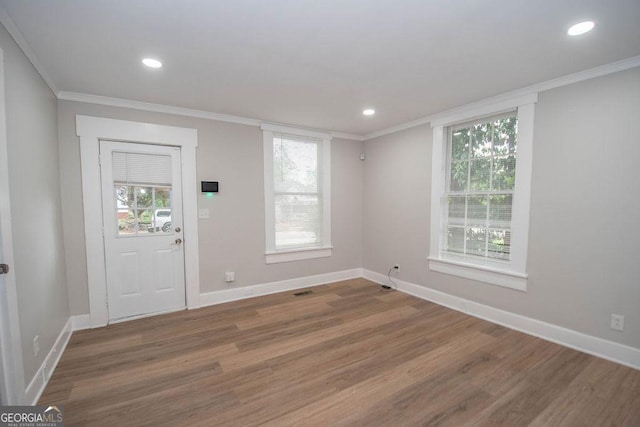 entrance foyer featuring recessed lighting, baseboards, ornamental molding, and wood finished floors
