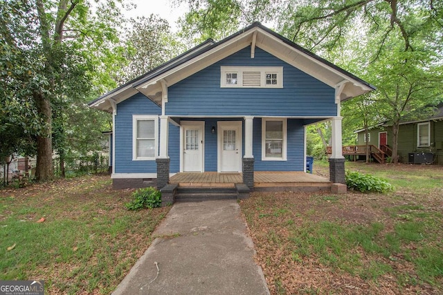 bungalow featuring cooling unit and a porch