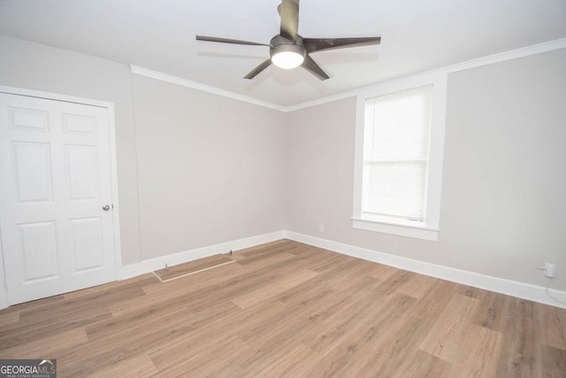 unfurnished room featuring baseboards, ornamental molding, light wood finished floors, and ceiling fan