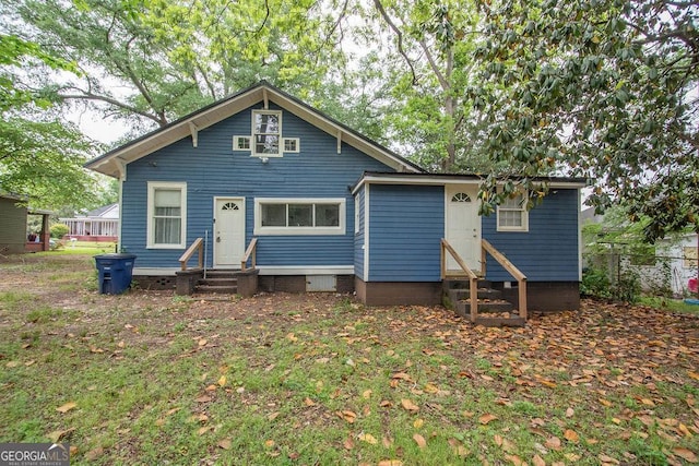 back of house with fence and entry steps
