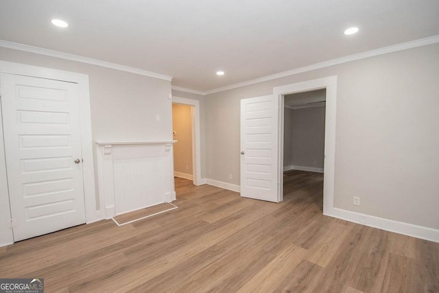 unfurnished bedroom with baseboards, a closet, light wood-style floors, ornamental molding, and recessed lighting