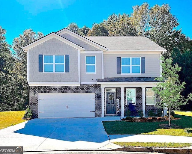 517 Starbuck Pkwy, Pendergrass, GA 30567 - view of front facade with brick siding, an attached garage, concrete driveway, and a front lawn
