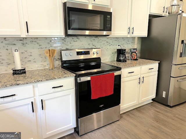517 Starbuck Pkwy, Pendergrass, GA 30567 - kitchen with stainless steel appliances and white cabinets