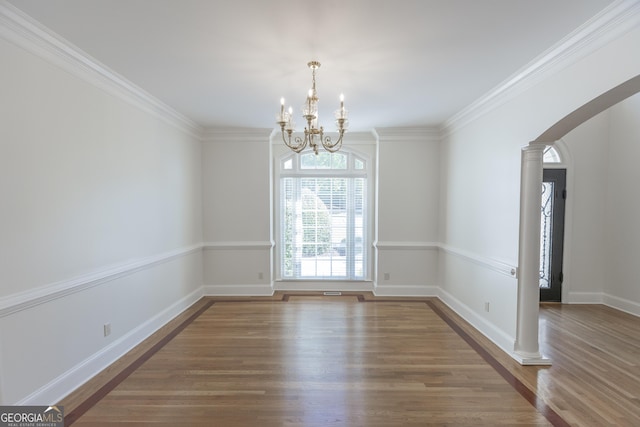 5685 Commons Ln, Alpharetta, GA 30005 - unfurnished dining area featuring ornamental molding, wood finished floors, and a chandelier