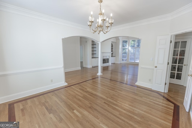 5685 Commons Ln, Alpharetta, GA 30005 - unfurnished dining area with crown molding, arched walkways, baseboards, and ornate columns