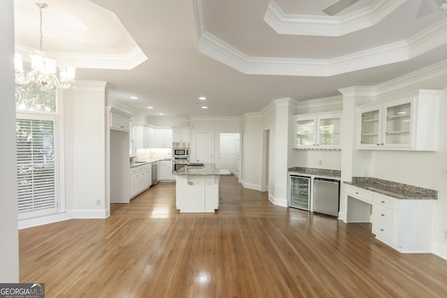 5685 Commons Ln, Alpharetta, GA 30005 - kitchen featuring appliances with stainless steel finishes, baseboards, wine cooler, and a healthy amount of sunlight