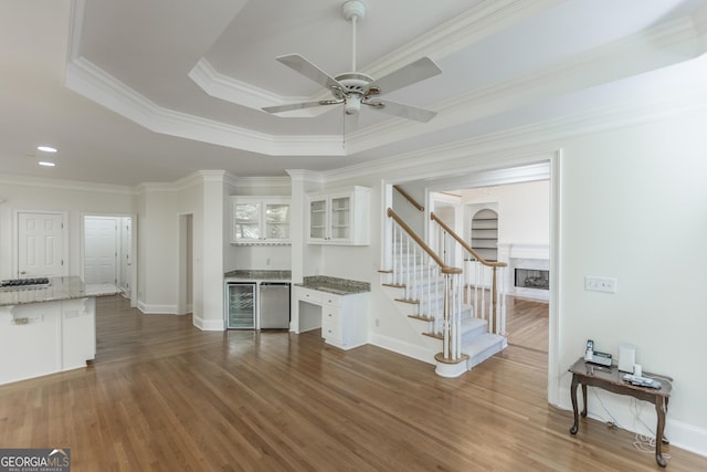 5685 Commons Ln, Alpharetta, GA 30005 - living room with stairs, a ceiling fan, dark wood-style floors, and a fireplace