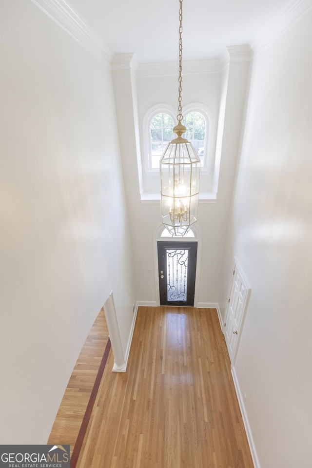 5685 Commons Ln, Alpharetta, GA 30005 - entrance foyer featuring visible vents, light wood-type flooring, baseboards, a chandelier, and ornamental molding
