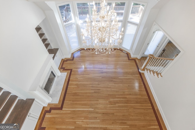 5685 Commons Ln, Alpharetta, GA 30005 - foyer entrance with baseboards, a chandelier, a healthy amount of sunlight, and light wood-type flooring
