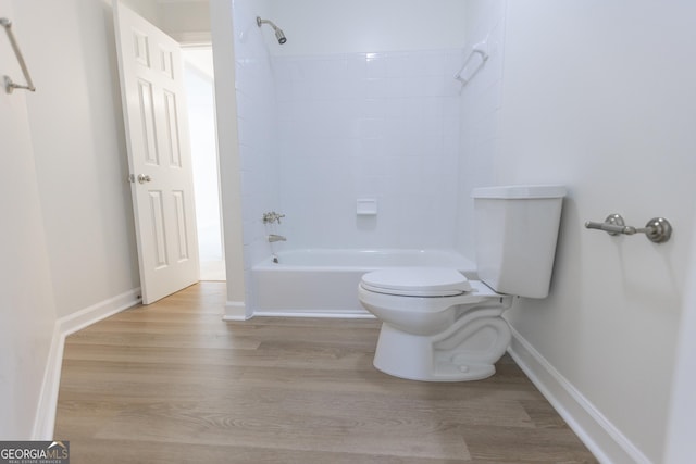 5685 Commons Ln, Alpharetta, GA 30005 - bathroom with baseboards, washtub / shower combination, wood finished floors, and toilet